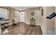 Cozy living area with hardwood floors, and a view into the home's front door at 10230 Danskin Dr, Las Vegas, NV 89166