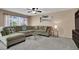 Comfortable living room with a plush sectional sofa, ceiling fan, and neutral decor at 10230 Danskin Dr, Las Vegas, NV 89166