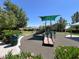 Community playground with a slide, play equipment, benches, and landscaping at 10230 Danskin Dr, Las Vegas, NV 89166