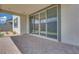Covered back patio with brick pavers and sliding glass doors at 10433 Smokey Mariposa Ave, Las Vegas, NV 89166