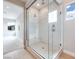 Bathroom featuring a glass-enclosed shower and wood look flooring at 10433 Smokey Mariposa Ave, Las Vegas, NV 89166