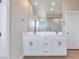 Bright bathroom featuring a dual sink vanity with large mirror and contemporary fixtures at 10433 Smokey Mariposa Ave, Las Vegas, NV 89166