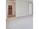 Spacious bedroom with neutral carpeting, walk-in closet, and white door with black hardware at 10433 Smokey Mariposa Ave, Las Vegas, NV 89166