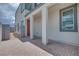 Paver patio and covered porch with gray trim and stucco walls at 10433 Smokey Mariposa Ave, Las Vegas, NV 89166
