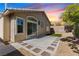 View of backyard featuring a concrete patio bordered with decorative stones and minimal lawn at 10540 Beachwalk Pl, Las Vegas, NV 89144
