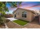 The backyard features a small lawn, low maintenance landscaping, and a covered patio at 10540 Beachwalk Pl, Las Vegas, NV 89144