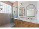 Bathroom features a double sink vanity, marble countertops, and a glass-enclosed shower with gold fixtures at 10540 Beachwalk Pl, Las Vegas, NV 89144