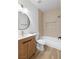 Bathroom with modern vanity and fixtures, including wood-look floors and bathtub with shower at 10540 Beachwalk Pl, Las Vegas, NV 89144