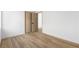 A clean and well-lit bedroom with wood-look flooring and neutral-colored walls at 10540 Beachwalk Pl, Las Vegas, NV 89144