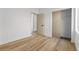 This bedroom includes wood-look flooring and a door that leads to an adjoining space and a closet at 10540 Beachwalk Pl, Las Vegas, NV 89144