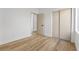 This bedroom includes wood-look flooring and a door that leads to an adjoining space and a closet at 10540 Beachwalk Pl, Las Vegas, NV 89144