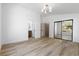 Spacious bedroom with mirrored closet and views of the bathroom, including wood look flooring at 10540 Beachwalk Pl, Las Vegas, NV 89144