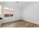 This bedroom features wood-look flooring and a window offering natural light at 10540 Beachwalk Pl, Las Vegas, NV 89144