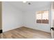 This bedroom boasts wood-look flooring and a window offering natural light at 10540 Beachwalk Pl, Las Vegas, NV 89144