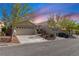 A charming single-Gathering home with a well-manicured front yard and a two-car garage at 10540 Beachwalk Pl, Las Vegas, NV 89144