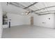 A spacious two-car garage featuring clean epoxy flooring and ample lighting at 10540 Beachwalk Pl, Las Vegas, NV 89144
