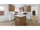 Modern kitchen with white and wood cabinets, stainless steel appliances, and a center island at 10540 Beachwalk Pl, Las Vegas, NV 89144