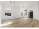 Bright living room with wood-look flooring and many windows offering a lot of natural light at 10540 Beachwalk Pl, Las Vegas, NV 89144