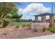 Arbors Tennis & Play Park entrance featuring a decorative sign and landscaped surroundings at 10540 Beachwalk Pl, Las Vegas, NV 89144