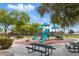 playground at The Crossing Park with vibrant play structures and picnic tables at 10540 Beachwalk Pl, Las Vegas, NV 89144