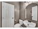 Cozy half-bath with a pedestal sink, modern fixtures, and a neutral color scheme at 11908 Menchaca Ln, Las Vegas, NV 89138