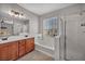 Bathroom featuring double sink vanity, tub and shower combination, and modern finishes at 11908 Menchaca Ln, Las Vegas, NV 89138