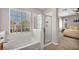 Bathroom featuring a tub and shower combination, white tile, and neutral finishes at 11908 Menchaca Ln, Las Vegas, NV 89138