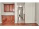 Well-lit hallway featuring hardwood floors, custom cabinetry, and access to a serene bedroom at 11908 Menchaca Ln, Las Vegas, NV 89138