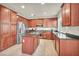 Spacious kitchen boasts wood cabinets, stainless steel appliances, and a functional kitchen island at 11908 Menchaca Ln, Las Vegas, NV 89138