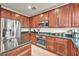 Gourmet kitchen featuring stainless steel appliances, granite countertops, and a gas cooktop range at 11908 Menchaca Ln, Las Vegas, NV 89138