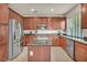 Bright kitchen features stainless steel appliances, dark countertops, and a kitchen island at 11908 Menchaca Ln, Las Vegas, NV 89138