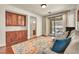 Comfortable living room with hardwood floors, custom cabinets, and sliding door access to patio at 11908 Menchaca Ln, Las Vegas, NV 89138