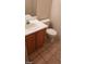 Bathroom vanity with wood cabinet and toilet in neutral tones at 1236 Dusty Creek St, Las Vegas, NV 89128