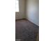 Bedroom boasts a large window, carpeted flooring, and ample natural light for a comfortable living space at 1236 Dusty Creek St, Las Vegas, NV 89128