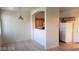 Open floor plan showing kitchen with wooden cabinets and a refrigerator adjacent to a dining room with tiled floor at 1236 Dusty Creek St, Las Vegas, NV 89128