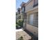 Exterior view of condo unit, showcasing covered entry, neutral color scheme and landscaped walkway at 1236 Dusty Creek St, Las Vegas, NV 89128