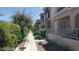 Exterior view of condos featuring landscaped walkway, covered entryways and neutral color palette at 1236 Dusty Creek St, Las Vegas, NV 89128