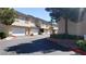 Exterior view of condo units showcasing a garage and well-maintained landscaping at 1236 Dusty Creek St, Las Vegas, NV 89128