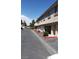 Well-maintained condo exteriors with individual garages, bushes, and convenient parking at 1236 Dusty Creek St, Las Vegas, NV 89128