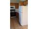 Galley kitchen with oak cabinets, a white microwave, and range at 1236 Dusty Creek St, Las Vegas, NV 89128