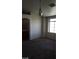 Living room with neutral walls, carpeted floors, and a window creating a bright and open area at 1236 Dusty Creek St, Las Vegas, NV 89128