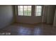 Living room with tiled floor and large windows for natural light at 1236 Dusty Creek St, Las Vegas, NV 89128