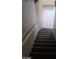 Carpeted stairs leading to tiled landing, combining comfort and easy maintenance at 1236 Dusty Creek St, Las Vegas, NV 89128