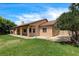 Backyard view featuring a covered patio, lush green lawn, and ample space for outdoor activities at 12780 Davis Wright Ct, Henderson, NV 89044