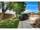 Spacious backyard featuring a well-maintained lawn, mature tree, and privacy fence at 12780 Davis Wright Ct, Henderson, NV 89044