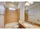 Full bathroom featuring tiled shower-tub combo and granite-topped vanity at 12780 Davis Wright Ct, Henderson, NV 89044
