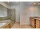 Bathroom featuring a walk-in shower, separate tub, and light wood vanity with granite counter at 12780 Davis Wright Ct, Henderson, NV 89044