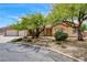 Charming single-story home with a three-car garage and mature trees in a well-kept front yard at 12780 Davis Wright Ct, Henderson, NV 89044