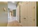 Hallway with tile floors, linen closet, and neutral paint throughout the residence at 12780 Davis Wright Ct, Henderson, NV 89044