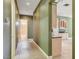 Hallway with neutral tile flooring that leads to bathroom and modern kitchen at 12780 Davis Wright Ct, Henderson, NV 89044